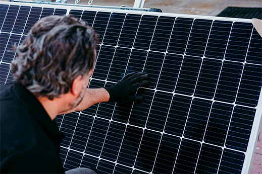 an expert installing solar panels